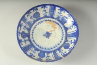 AN ISLAMIC CIRCULAR BLUE AND WHITE PLATE. 9ins diameter.