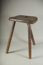 A PRIMITIVE THREE LEGGED CUTLER'S STOOL. 19ins high