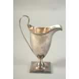 A GEORGE III SILVER HELMET SHAPED CREAM JUG. 5.25ins high. London 1795.