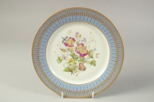 A 19TH CENTURY SEVRES PLATE, painted flower under a blue and gilt border, marked S61 for 1861.