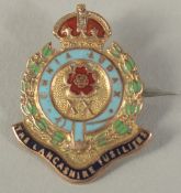 A 9CT GOLD AND ENAMEL LANCASHIRE FUSILIER BROOCH.