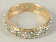 A 9CT GOLD EMERALD AND DIAMOND ETERNITY RING