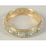 A 9CT GOLD EMERALD AND DIAMOND ETERNITY RING