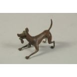 A BRONZE OKIMONO of a Dog. 6cms long.