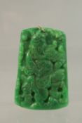 A CHINESE CARVED GREEN JADE PENDANT with gold ring. 6cms x 3.5cms.