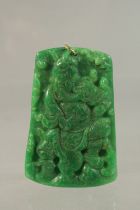 A CHINESE CARVED GREEN JADE PENDANT with gold ring. 6cms x 3.5cms.