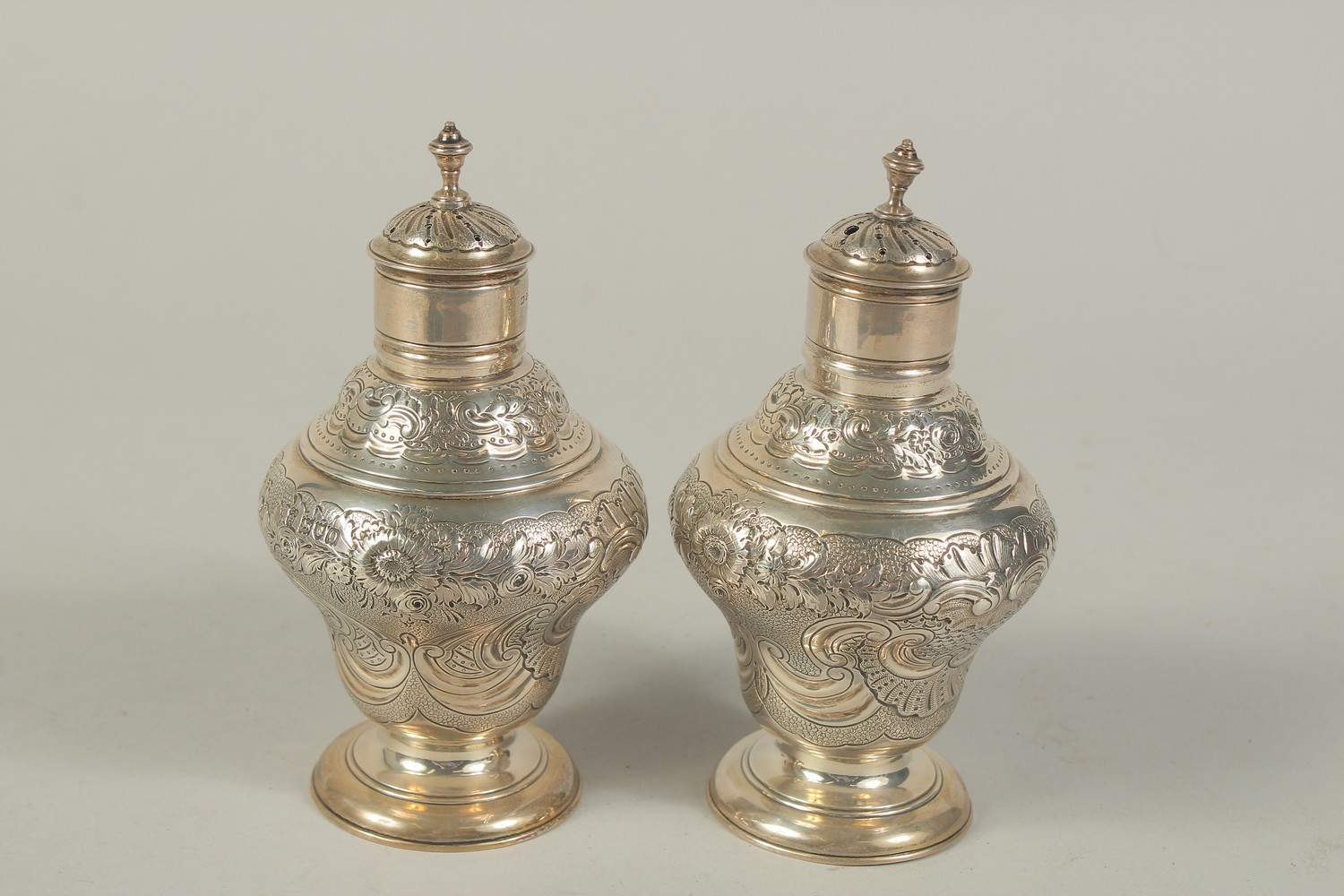 A PAIR OF VICTORIAN SILVER SUGAR CASTERS with repousse decoration and scrolls. London 1909. Maker: - Image 3 of 4