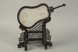 A CHINESE WHITE JADE FAN on a wooden stand. 12ins high.