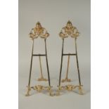 A SMALL PAIR OF BRONZE EASELS. 22ins high.