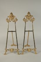 A SMALL PAIR OF BRONZE EASELS. 22ins high.