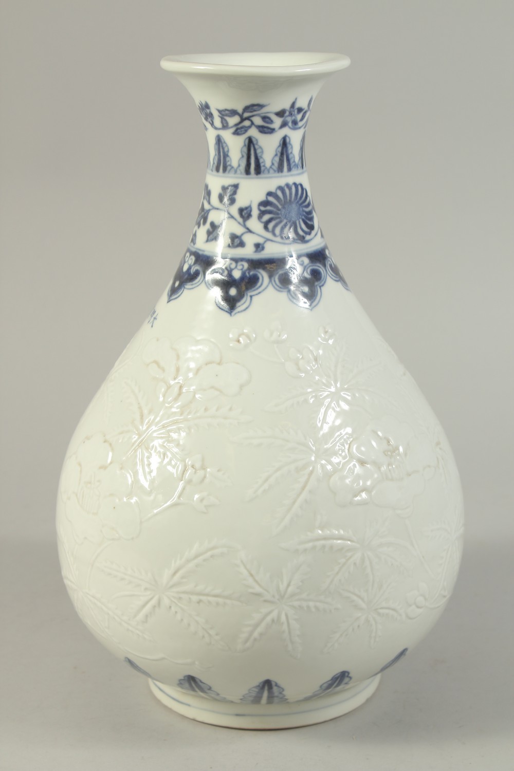 A CHINESE BLUE AND WHITE CARVED FLORAL YUHUCHUNPIN VASE. 32cms high. - Image 4 of 6