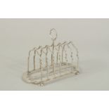 A SIX DIVISION SILVER TOAST RACK on four ball feet. London 1903. Weight: 7ozs.