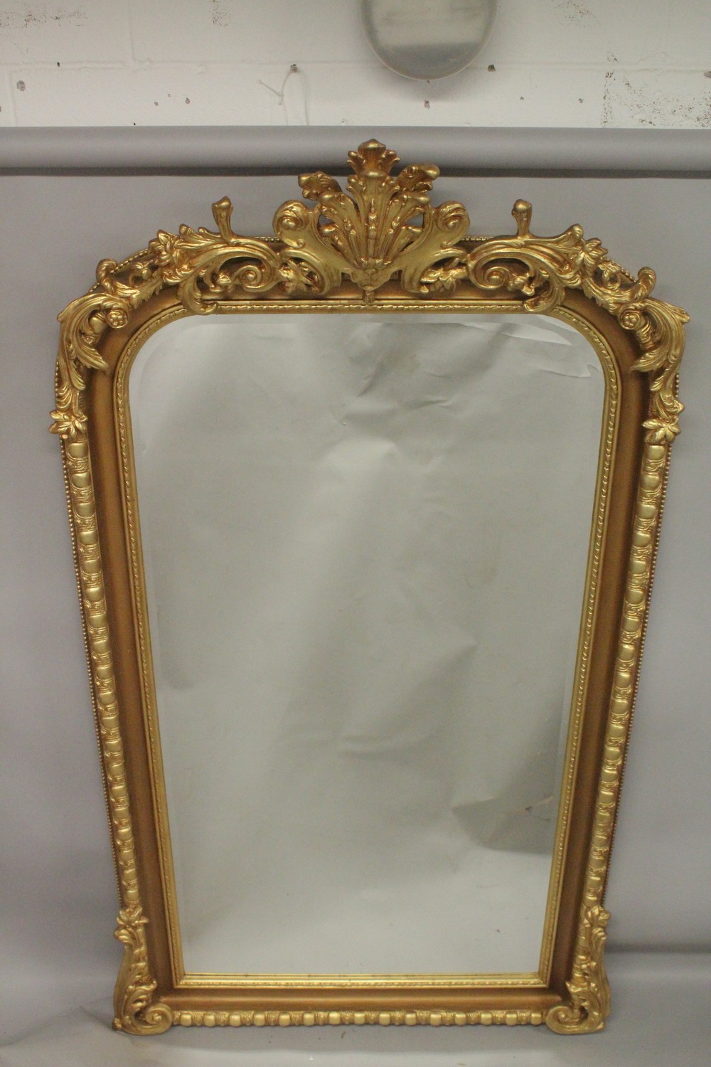 A GOOD LARGE GILT FRAMED VICTORIAN STYLE PIER MIRROR with decorative cresting. 7ft 3ins x 4ft 2ins.