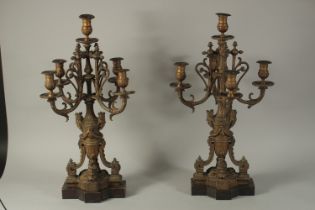 A LARGE PAIR OF 19TH CENTURY ORMOLU CANDLESTICKS with four scrolling branches, mask and garlands.