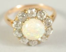 A GOOD OPAL AND DIAMOND CLUSTER RING with central opal and ten diamonds. Size M.