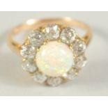 A GOOD OPAL AND DIAMOND CLUSTER RING with central opal and ten diamonds. Size M.