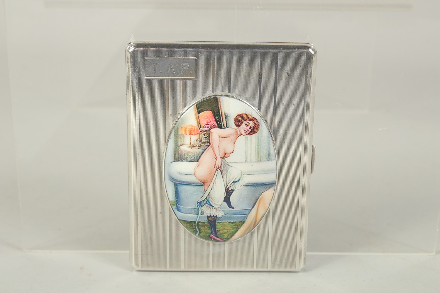 AM EDWARD VII ENGINE TURNED SILVER CIGARETTE CASE with an oval enamel, a girl getting into a bath.