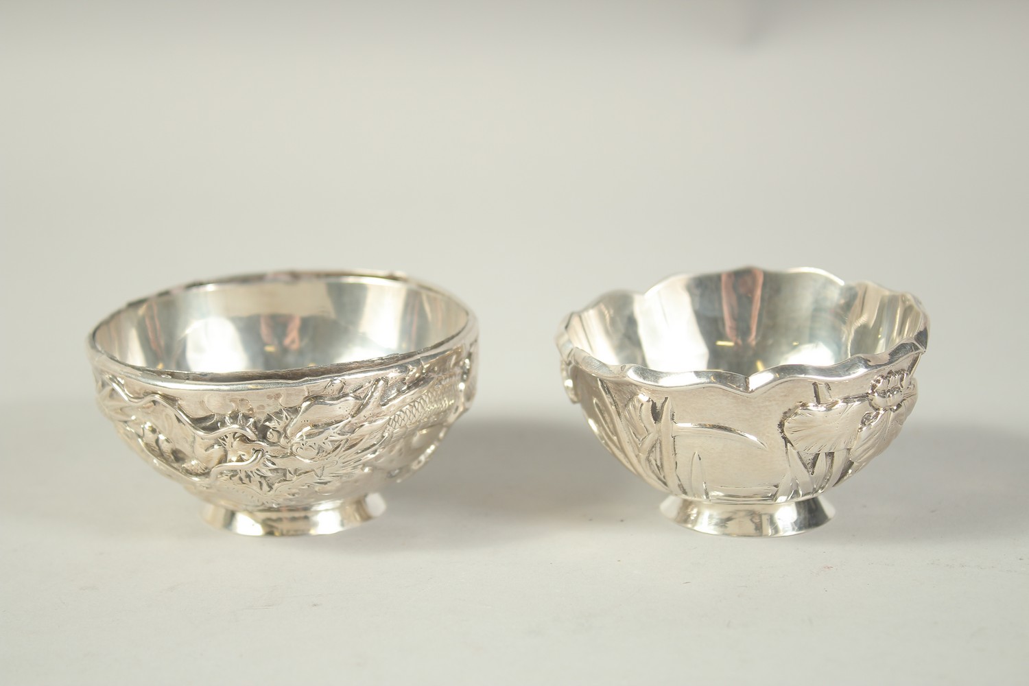 TWO SMALL CHINESE SLIVER CIRCULAR BOWLS. 3ins diameter.