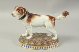 A MEISSEN MODEL OF A HUNTING DOG first modelled by Gottlob Luck. Circa. 1840. 20cm high. Cross sword
