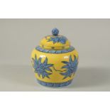 A CHINESE YELLOW GROUND BLUE AND WHITE PORCELAIN JAR AND COVER. 17cms high.