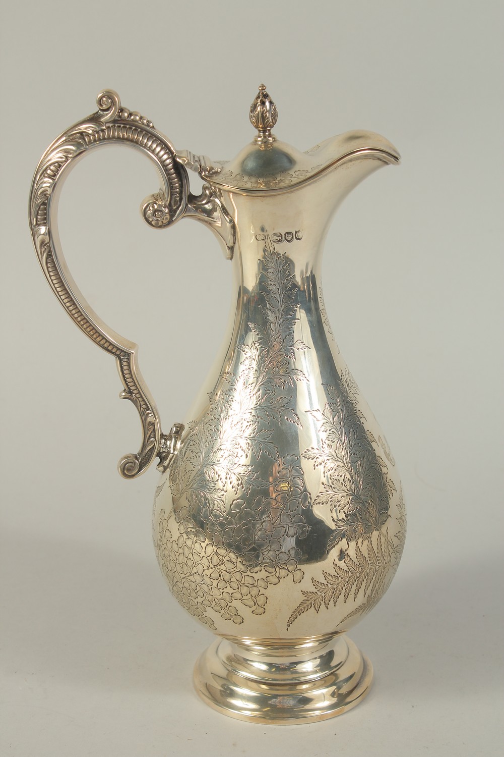 A VICTORIAN SILVER ENGRAVED CLARET JUG. London 1891. Maker: C. B. Weight: 17ozs.