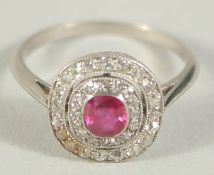 A RUBY AND DIAMOND CLUSTER RING. Size M1/2.