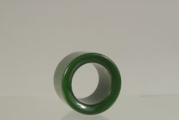 A PLAIN JADE ARCHERS RING. 3cms diameter.