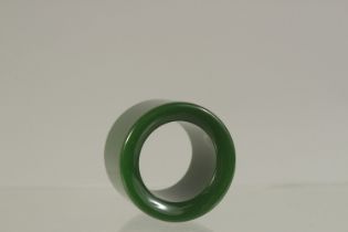 A PLAIN JADE ARCHERS RING. 3cms diameter.