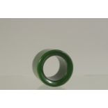 A PLAIN JADE ARCHERS RING. 3cms diameter.