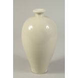 A CHINESE WHITE GLAZED DING WARE MEIPING VASE. 20.5cms high.