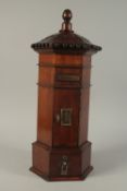 A GOOD GEORGIAN STYLE MAHOGANY POSTBOX with carved top, brass letter flap, door and drawer below.