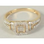 A 9 CT GOLD DIAMOND CLUSTER RING with princess cut diamonds.