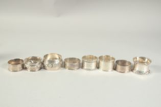 EIGHT VARIOUS SILVER SERVIETTE RINGS.