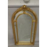 A GOOD LARGE GILT FRAMED VICTORIAN STYLE ARCH TOP MIRROR. 7ft 4ins x 3ft 8ins wide.