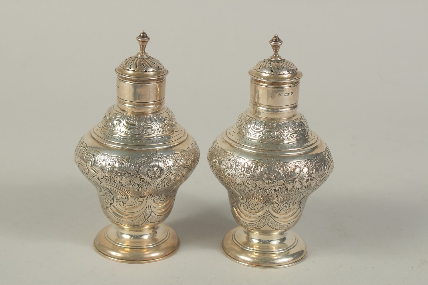 A PAIR OF VICTORIAN SILVER SUGAR CASTERS with repousse decoration and scrolls. London 1909. Maker: - Image 2 of 4