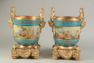 A PAIR OF SEVRES DESIGN PORCELAIN AND GILDED METAL TWO-HANDLED URNS, with a continuous pattern of