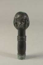 A BRONZE WALKING STICK HANDLE "FOUR SIDED HEAD". 15cms.