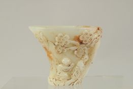 A CHINESE CARVED WHITE JADE LIBATION CUP. 3.5ins high.