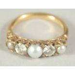 A THREE STONE PEARL AND TWO STONE DIAMOND RING. Size I.