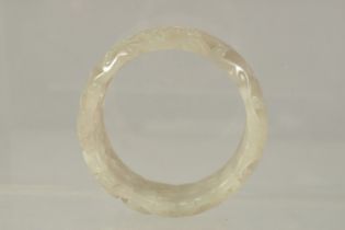 A GOOD CHINESE PIERCED AND CARVED BANGLE. 7cms diameter x 3cms deep.