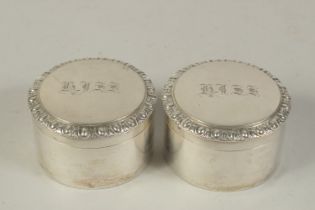 A PAIR OF GEORGIAN SILVER CIRCULAR POTS AND COVERS, engraved "HISS". 3ins diameter.