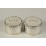 A PAIR OF GEORGIAN SILVER CIRCULAR POTS AND COVERS, engraved "HISS". 3ins diameter.