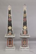 A GOOD PAIR OF COLOURED MARBLE OBELISKS ON STANDS. 6ft high.