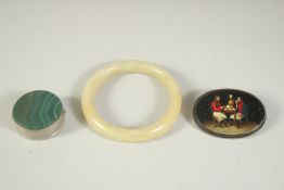 A CIRCULAR AGATE PILL BOX , lacquer oval brooch and a jade bracelet. (3).