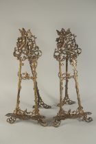 A MEDIUM PAIR OF BRONZE EASELS. 24ins high.