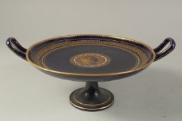 A COMMEMORATIVE TAZZA OR COMPORT, with deep blue ground, having a central gilt cicular panel with