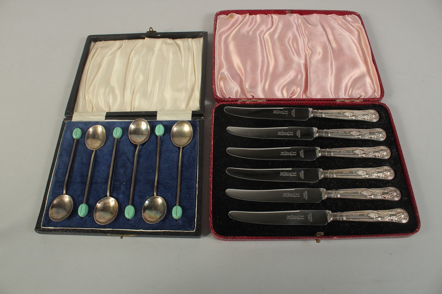 A SET OF SIX SILVER HANDLED TEA KNIVES AND SIX BEAN END COFFEE SPOONS, both cased.