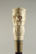 A CARVED BONE HANDLED WALKING STICK 