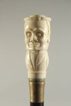 A CARVED BONE HANDLED WALKING STICK "HEAD".