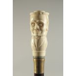 A CARVED BONE HANDLED WALKING STICK "HEAD".